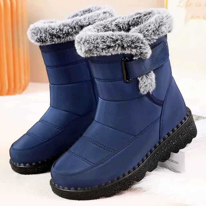 Zylvaia blue quilted mid-calf winter boots featuring plush faux fur lining, an adjustable side strap with a buckle, and a deep lugged rubber sole for ultimate warmth and traction.