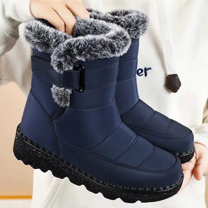 Zylvaia navy blue quilted winter boots with plush faux fur trim and a chunky lugged sole, held for display.