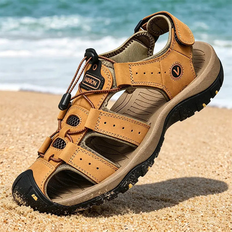 Men's Zynath outdoor fisherman sandals in tan genuine leather, featuring a quick-lace system and hook-and-loop ankle strap, resting on a sandy beach.