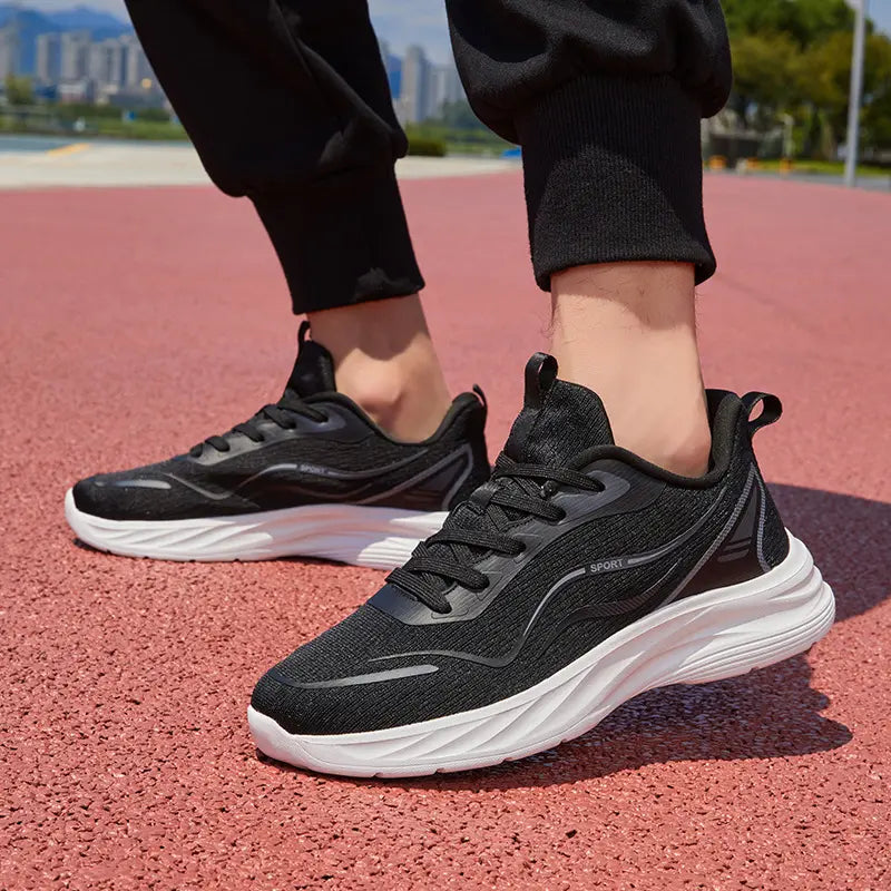 Men's black Zynthos breathable running trainers with white sculpted midsoles and reflective heel accents, shown in a lifestyle context on an outdoor track.