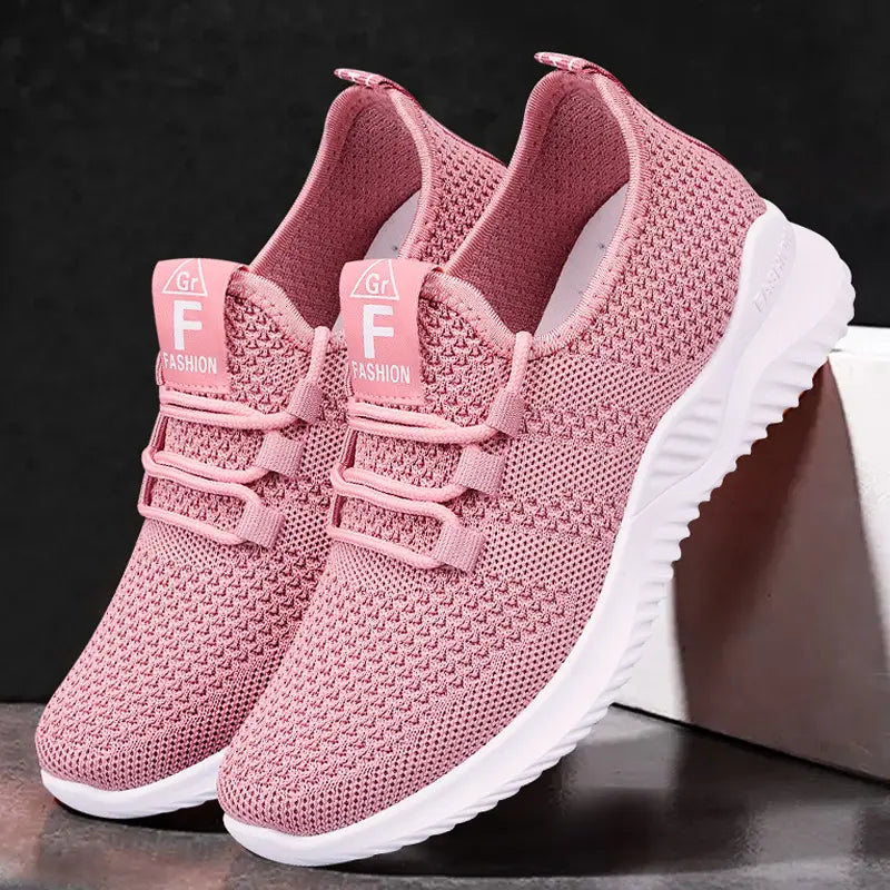 Zyphor women's soft pink breathable mesh sneakers shown in a three-quarter front view, featuring integrated non-functional laces and a white sculpted sole with subtle 'FASHION' branding.