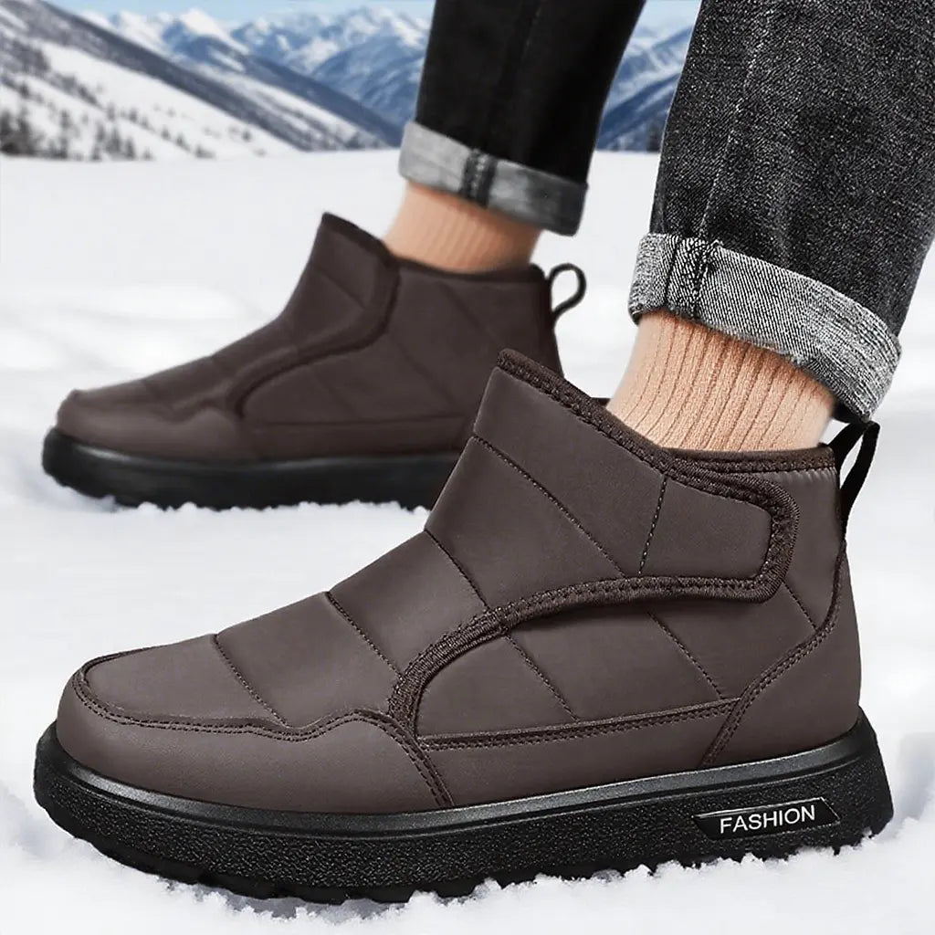 Men's Zyrkon brown quilted puffer winter boots with a velcro strap and 'FASHION' branded lug sole, shown in a snowy landscape setting.